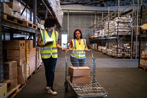 Two women checking a company's supply chain with the help of technology. 