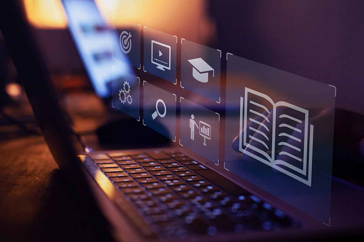 A laptop screen displays icons of a book, a cap, a magnifying glass, gears and a playback screen. 