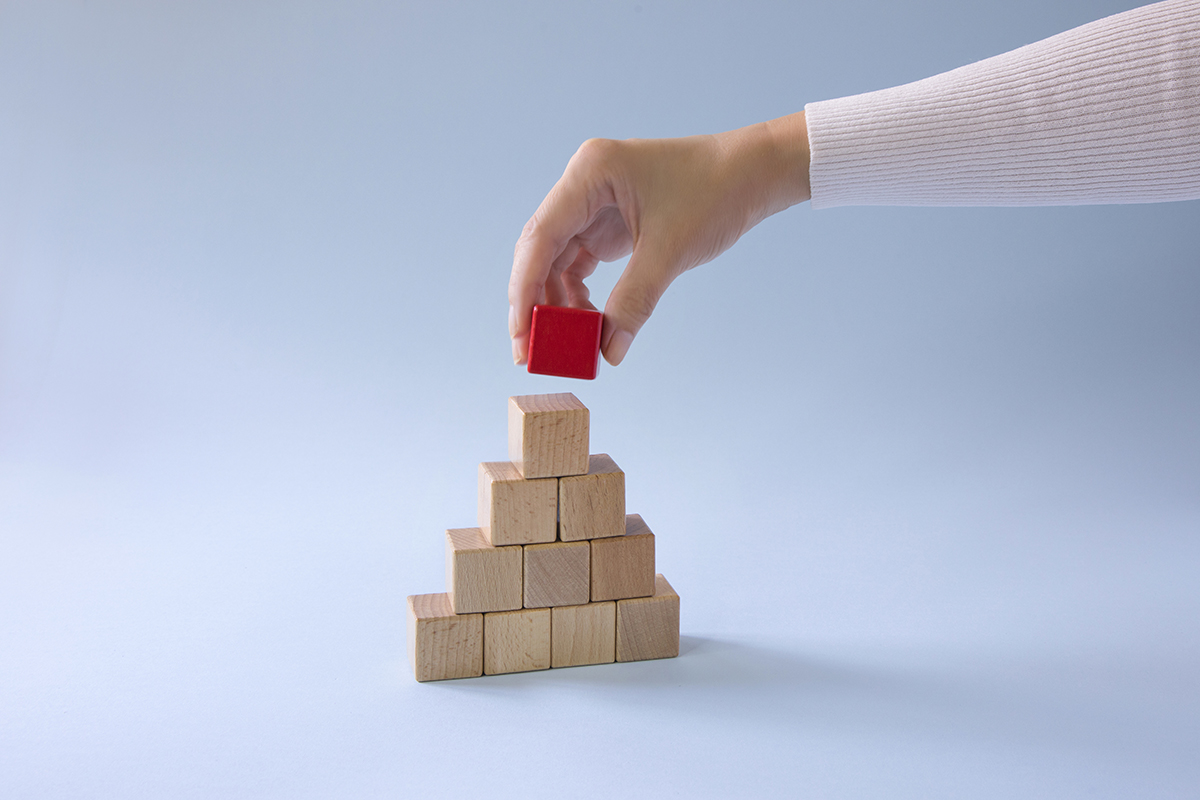 Pyramid of Urgency: pyramid made with wooden cubes. 