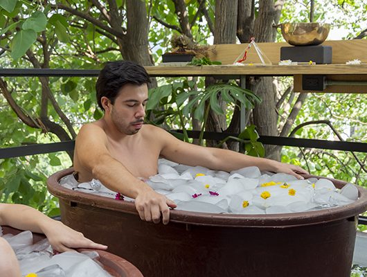 An athlete receiving a cold water immersion treatment after training. An athlete receiving a cold water immersion treatment after training.