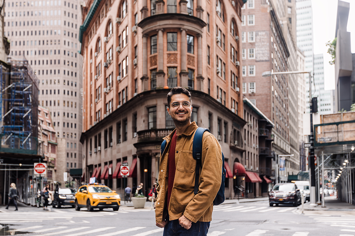 Portrait of a happy smiling man on the streets of Manhattan Downtown, New York, USA.