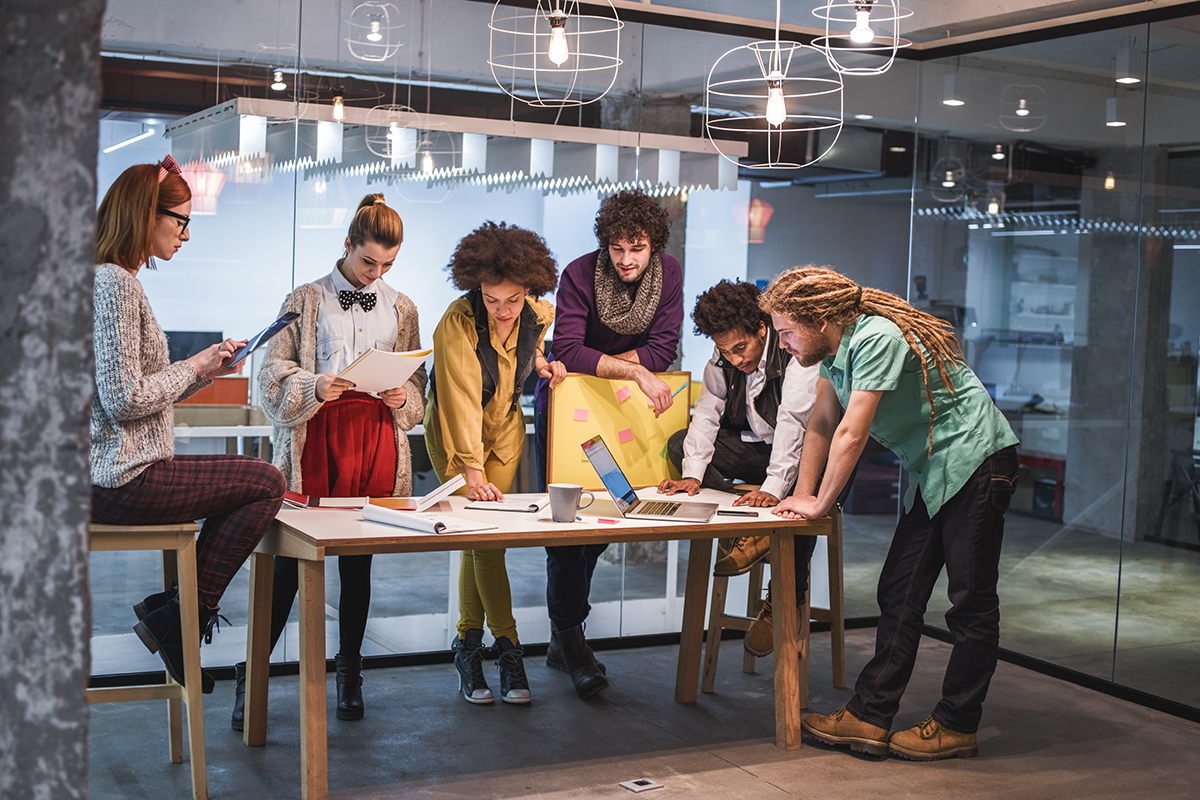 A group of workers meet to discuss the different aspects of a project. 